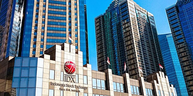 Modern manufacturing facility with automated production lines, IoT sensors monitoring equipment, and real-time efficiency dashboards showing 40% productivity improvement